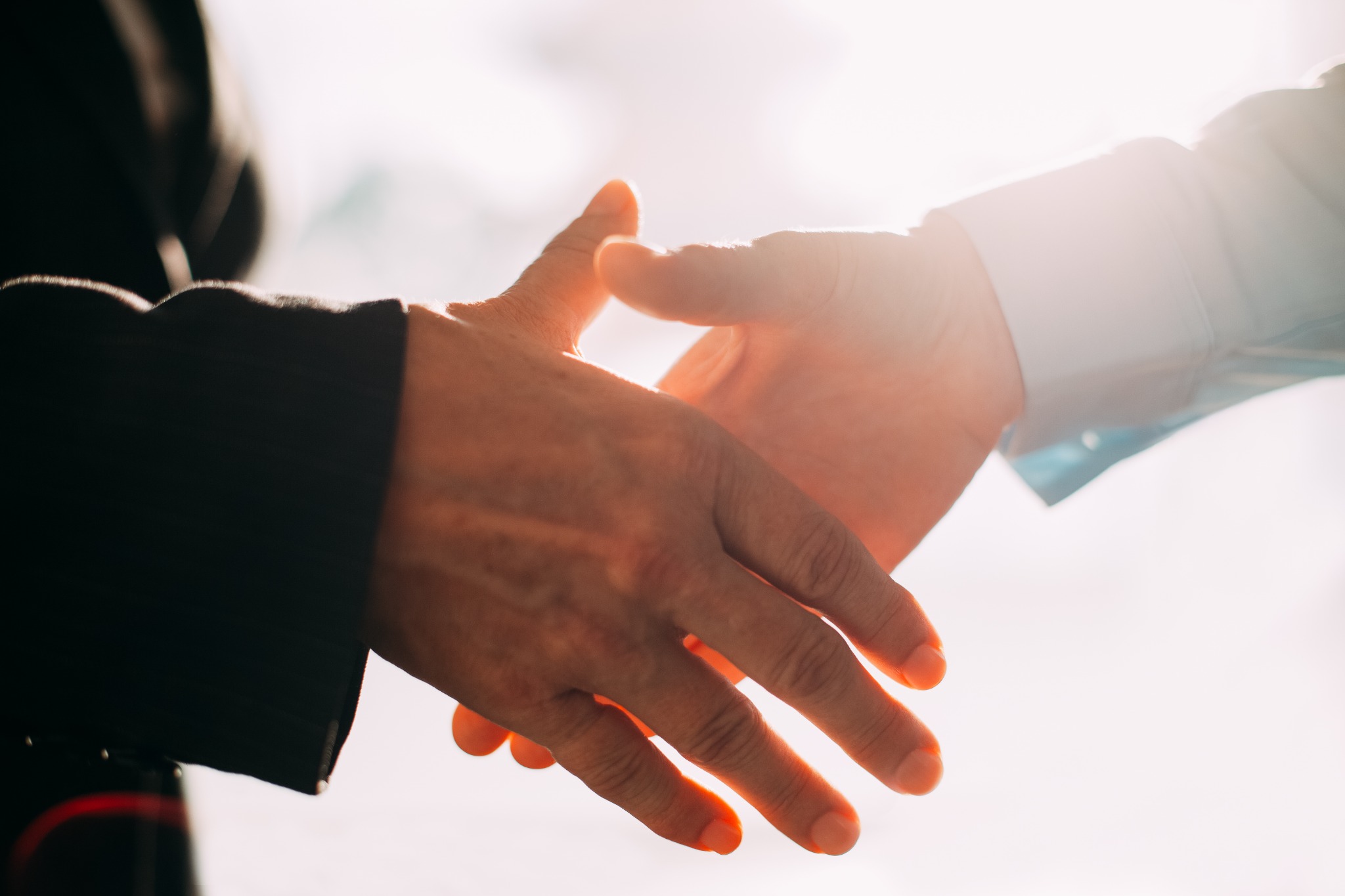 Handshake in sunlight